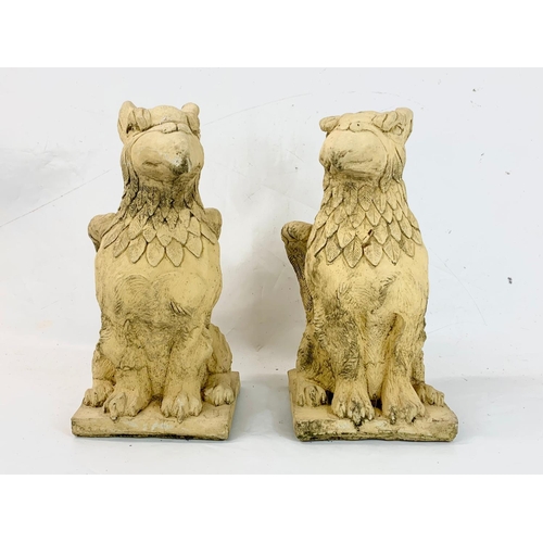 262 - A pair of concrete garden Griffin ornaments. 50cm