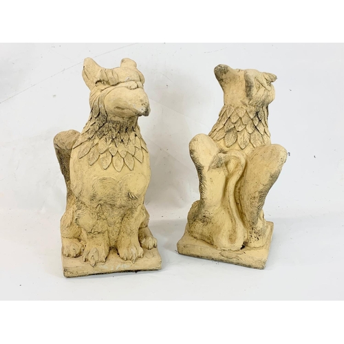 262 - A pair of concrete garden Griffin ornaments. 50cm