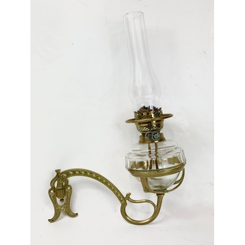 28 - A Victorian wall hanging oil lamp. 34 x 42cm.