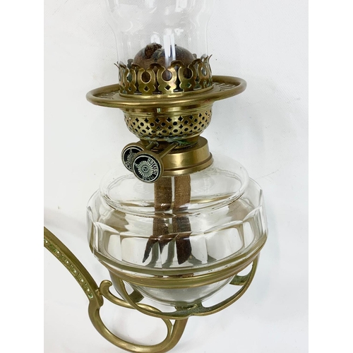 28 - A Victorian wall hanging oil lamp. 34 x 42cm.