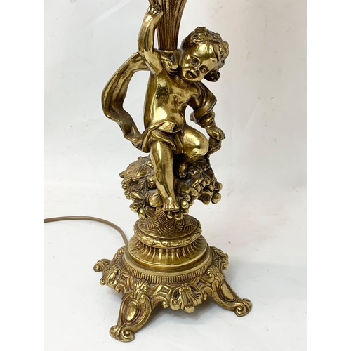 283 - A large ornate brass table lamp with amber glass panels. 73cm