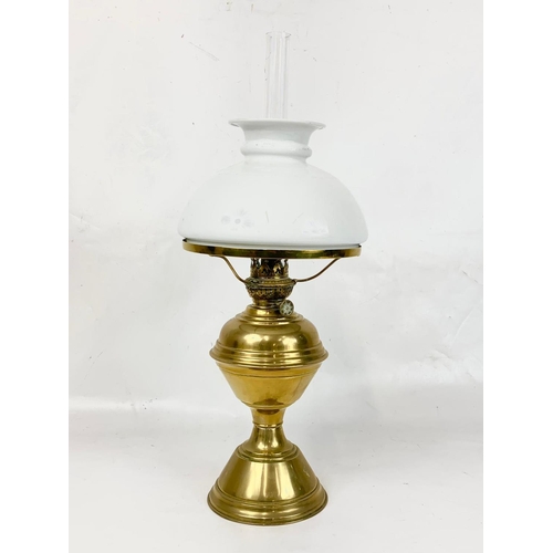 29 - A good quality early 20th century brass oil lamp with glass shade. 51cm.