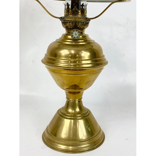 29 - A good quality early 20th century brass oil lamp with glass shade. 51cm.