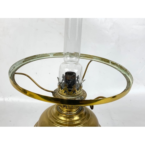 29 - A good quality early 20th century brass oil lamp with glass shade. 51cm.