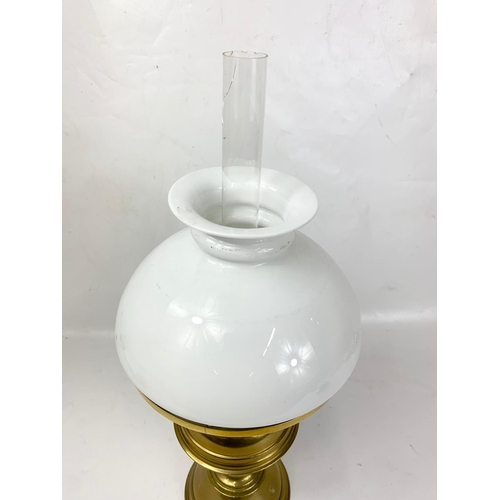 29 - A good quality early 20th century brass oil lamp with glass shade. 51cm.