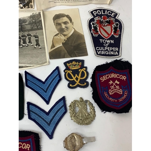 291 - A collection of police and military badges etc.