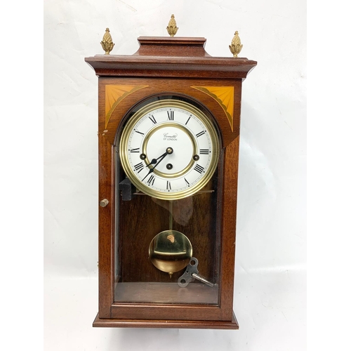 3 - An inlaid mahogany wall clock. Comitti of London. 52cm