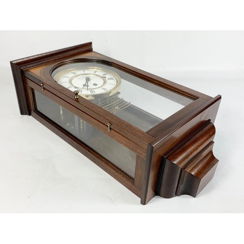 3 - An inlaid mahogany wall clock. Comitti of London. 52cm