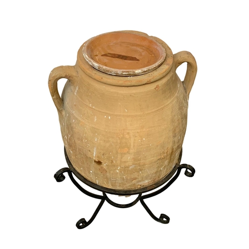 307 - A large stone garden urn on stand. 70cm