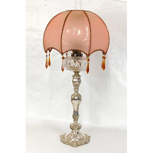 31 - A large Victorian silver plated oil lamp with an early 20th century shade. 83cm.