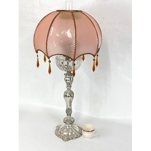 31 - A large Victorian silver plated oil lamp with an early 20th century shade. 83cm.