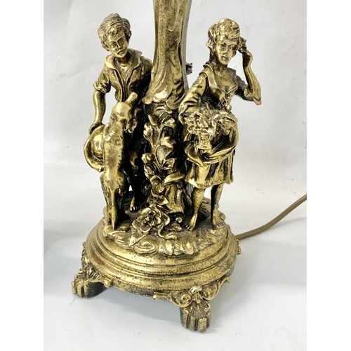 319 - 2 ornate gilt table lamps. 56cm.