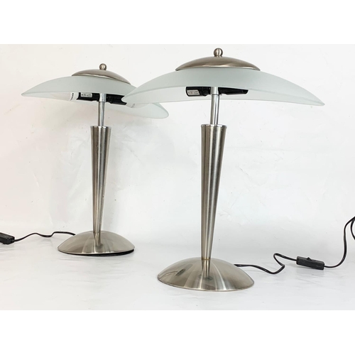 32 - A pair of Art Deco style chrome table lamps with frosted glass shades. 41 x 48cm.