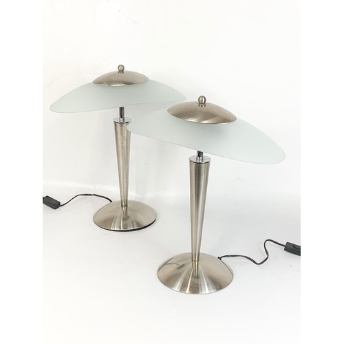 32 - A pair of Art Deco style chrome table lamps with frosted glass shades. 41 x 48cm.