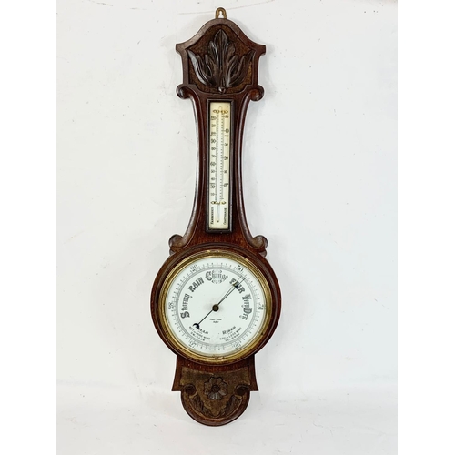 35 - A late Victorian oak barometer. 82cm.