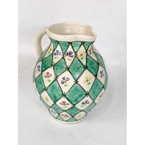 409 - A Charlotte Rhead pottery jug for Bursley Ware. 673. 20 x 21.5cm