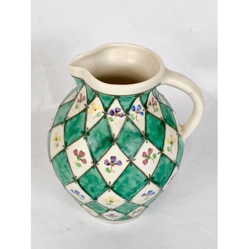 409 - A Charlotte Rhead pottery jug for Bursley Ware. 673. 20 x 21.5cm