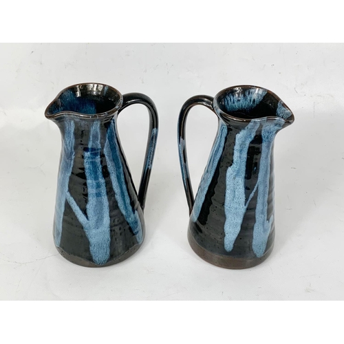 413 - A pair of Cliff Pottery Youghal studio stoneware jugs. 18.5cm