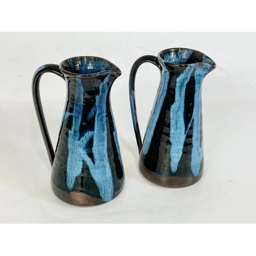 413 - A pair of Cliff Pottery Youghal studio stoneware jugs. 18.5cm