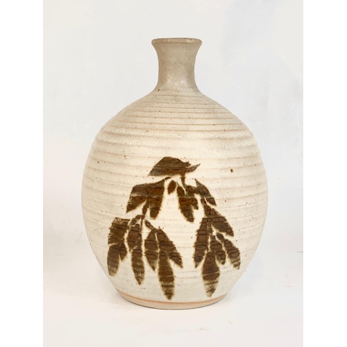 416 - A stoneware pottery jug. 17cm