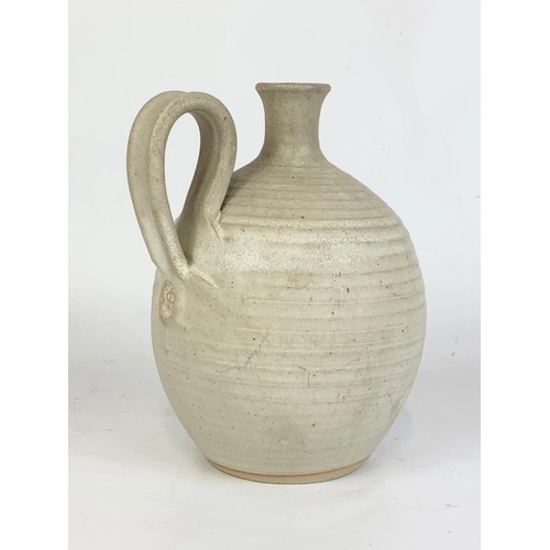 416 - A stoneware pottery jug. 17cm