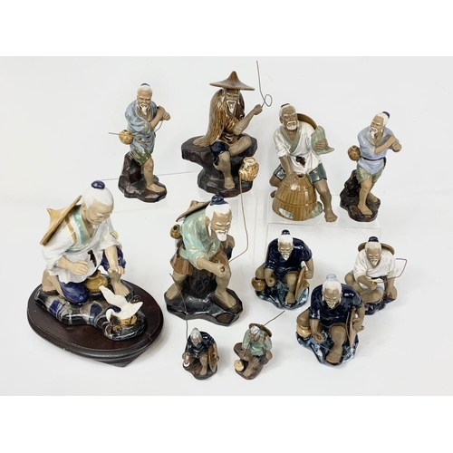 445 - A collection of vintage Chinese Mudman pottery figures. Largest 21 x 24cm.