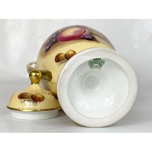 458 - 2 pieces of Aynsley “Orchard Gold” pottery. Signed D. Jones. An urn and a Cup and saucer. Urn measur... 