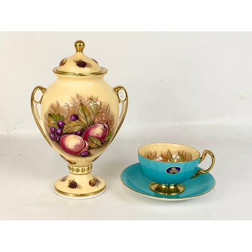 458 - 2 pieces of Aynsley “Orchard Gold” pottery. Signed D. Jones. An urn and a Cup and saucer. Urn measur... 