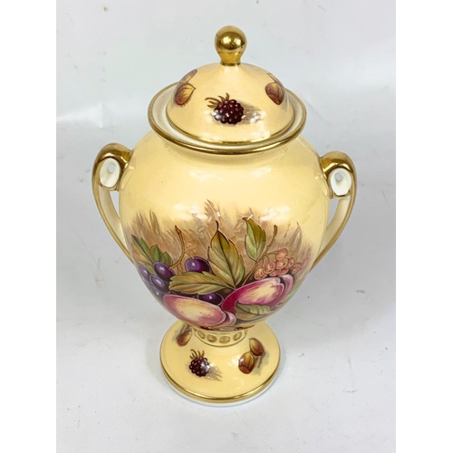 458 - 2 pieces of Aynsley “Orchard Gold” pottery. Signed D. Jones. An urn and a Cup and saucer. Urn measur... 