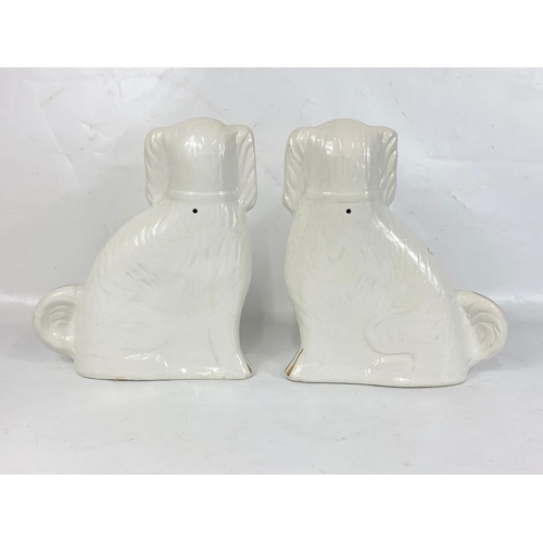 503 - A pair of large Victorian Staffordshire pottery dogs. 28 x 34cm