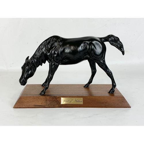 512 - A Beswick pottery horse on stand. 27 x 18cm including stand.