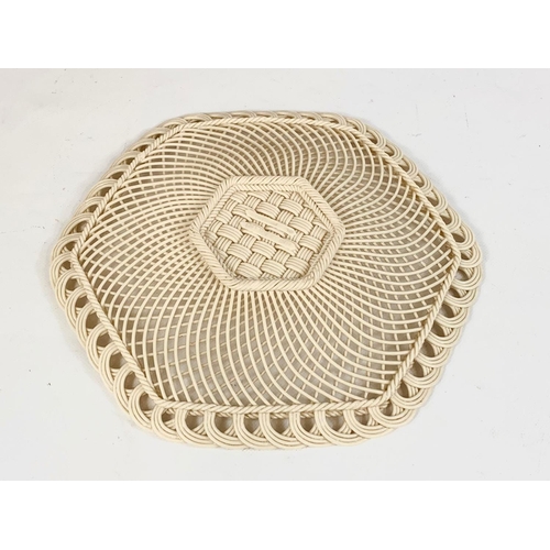 519 - A Belleek woven pottery plate. 25cm