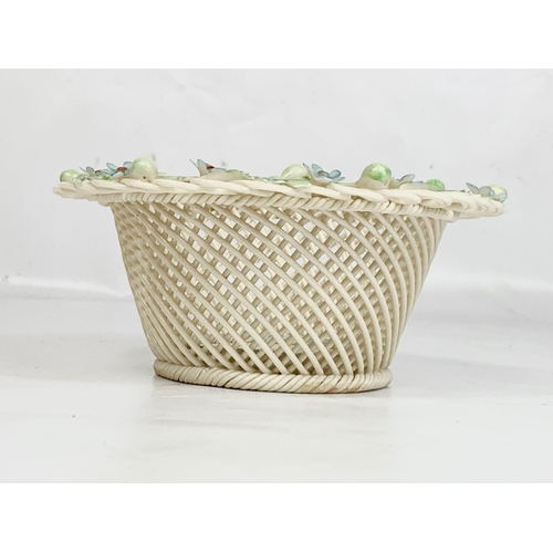 520 - A Belleek woven pottery basket. 15 x 6cm.