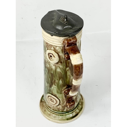 524 - A tall late 19th century Majolica stein with pewter lid. 31cm