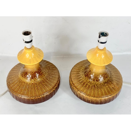 525 - A pair of signed Mid Century pottery table lamps. Stamped H. 23 x 31cm