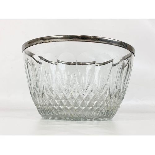 540 - A large crystal bowl with silver plated rim and a crystal claret jug with silver plated top. Bowl me... 