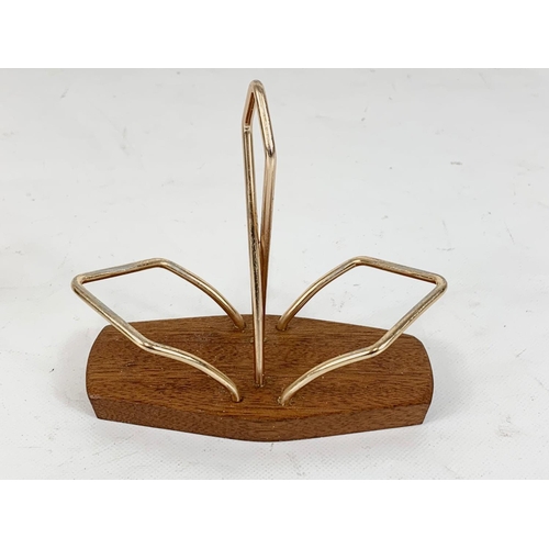 545 - A Mid Century teak and brass salt and pepper holder.