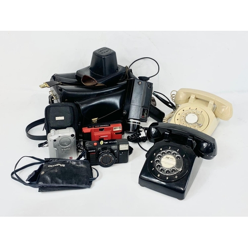 58 - A quantity of cameras and vintage telephones.