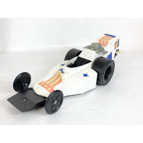 59 - A collection of vintage toys. An Evel Knievel Formula 1 Dragster car by Ideal 1974, a 1971 Hasbro Sc... 