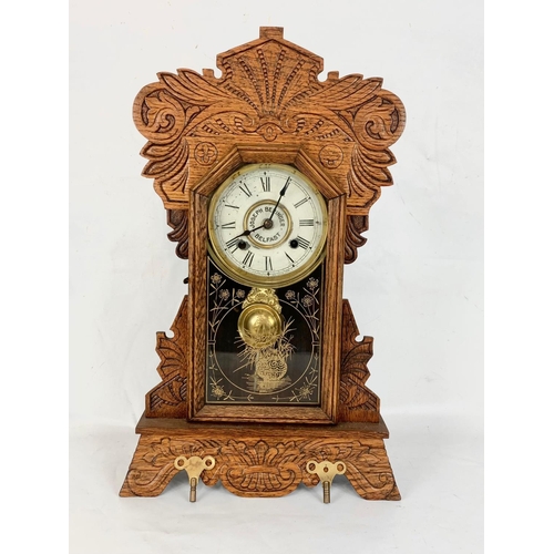 62 - A late 19th century New Haven Clock Company mantle Gingerbread clock with key and pendulum. Joseph B... 