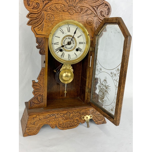 62 - A late 19th century New Haven Clock Company mantle Gingerbread clock with key and pendulum. Joseph B... 