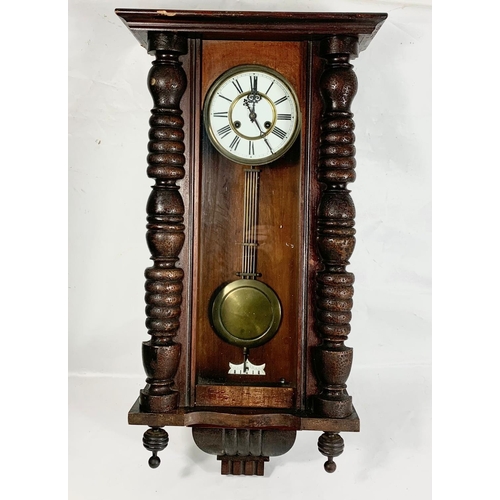 64 - A large Victorian Vienna wall clock with pendulum. 84cm