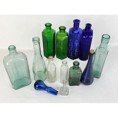 69 - A quantity of early 20th century chemist and other glass bottles etc.