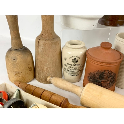 76 - A quantity of vintage kitchenware and stone bottles, Victorian jelly mould, baking bowl etc.