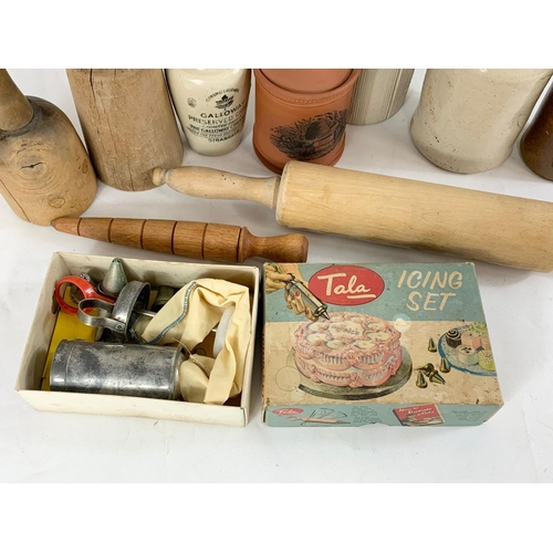 76 - A quantity of vintage kitchenware and stone bottles, Victorian jelly mould, baking bowl etc.