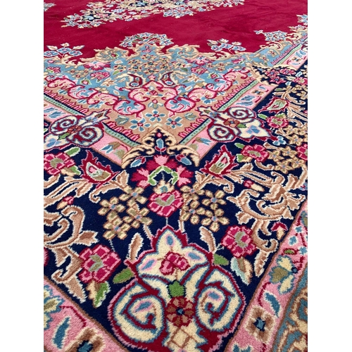 788 - A very large vintage Middle Eastern hand knotted rug. 299 x 404cm