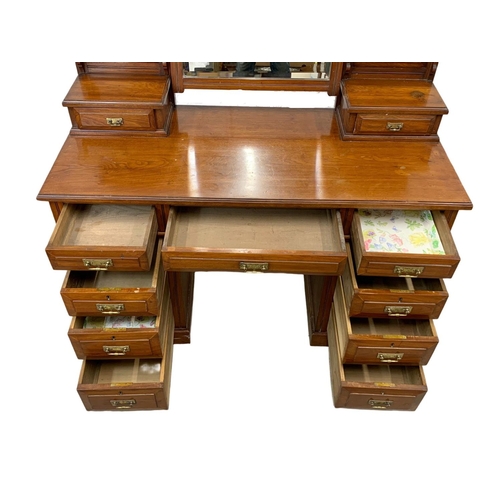 793 - A late Victorian walnut dressing table. Circa 1900. 127 x 55.5 x 166.5cm