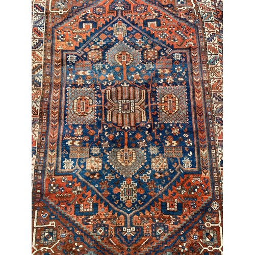 799 - A large vintage Middle Eastern hand knotted rug. 178.5 x 280cm.