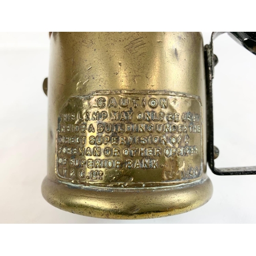 80 - A military blow torch. Crows Feet stamp. With caution plaque.