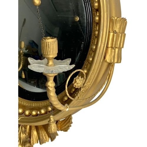 802a - A Thomas Fentham Regency gilt framed convex mirror. Circa 1810-1815. 59 x 90cm